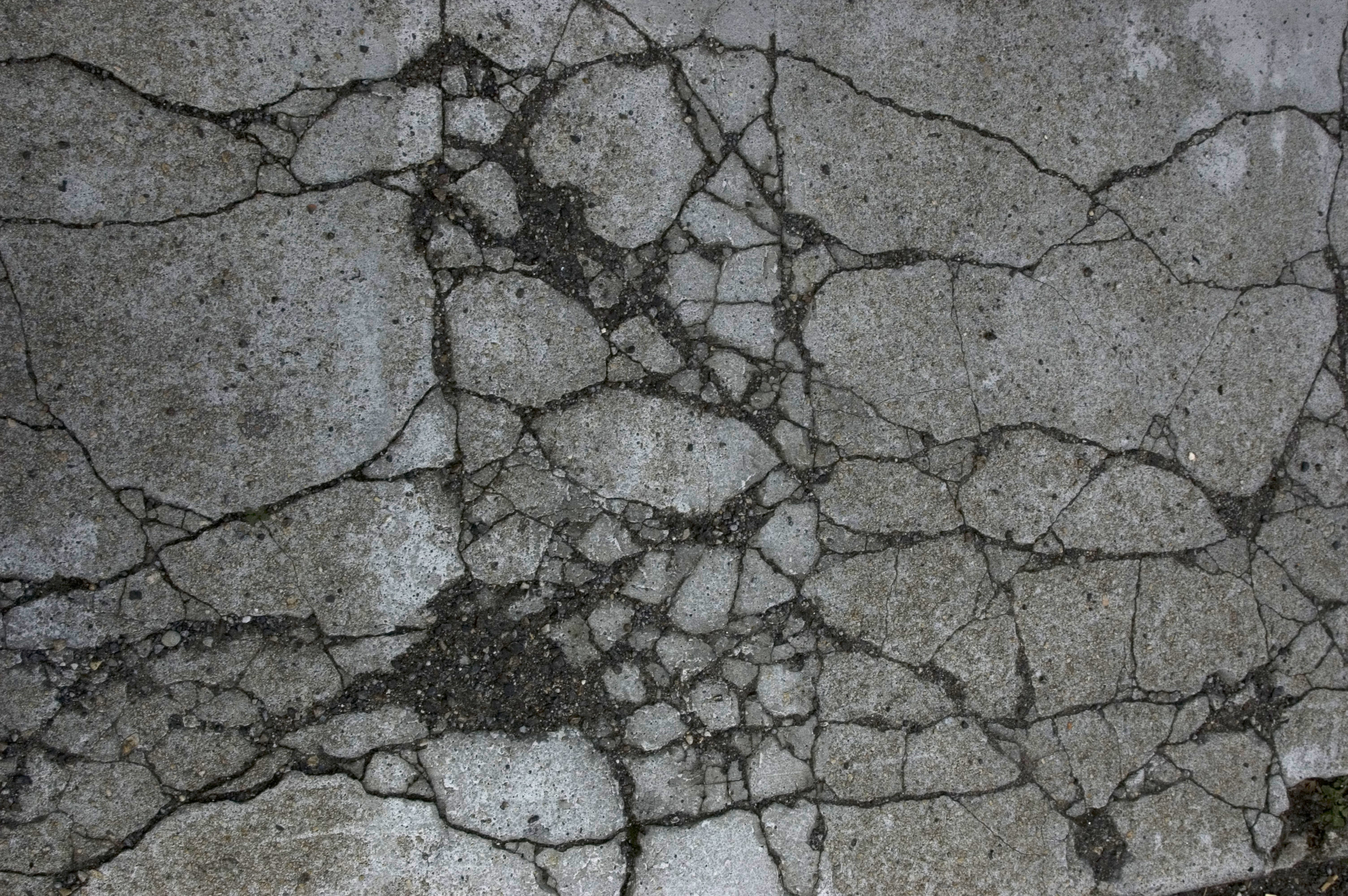 Damaged and broken asphalt background, texture