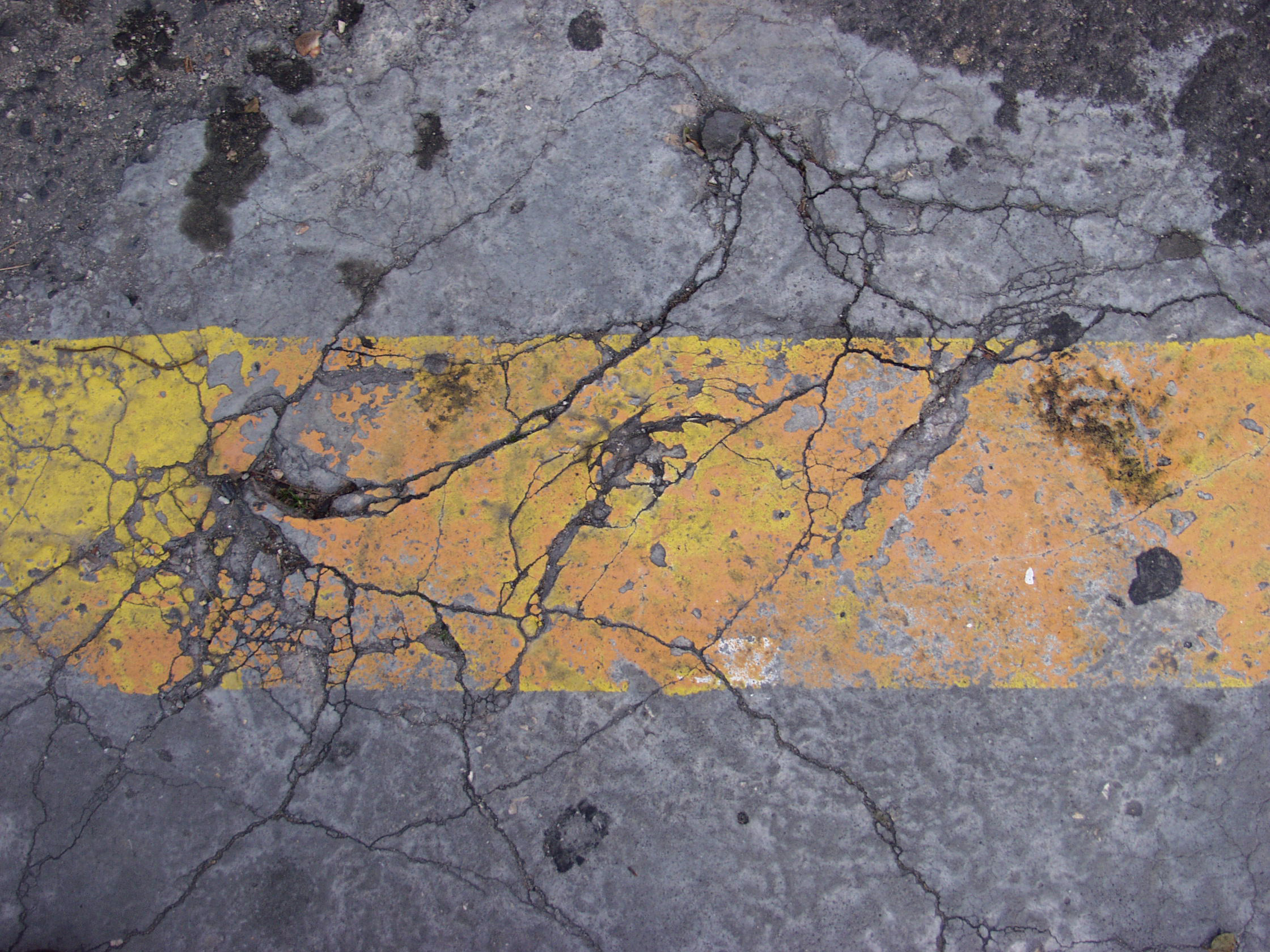 Damaged and broken asphalt background, texture